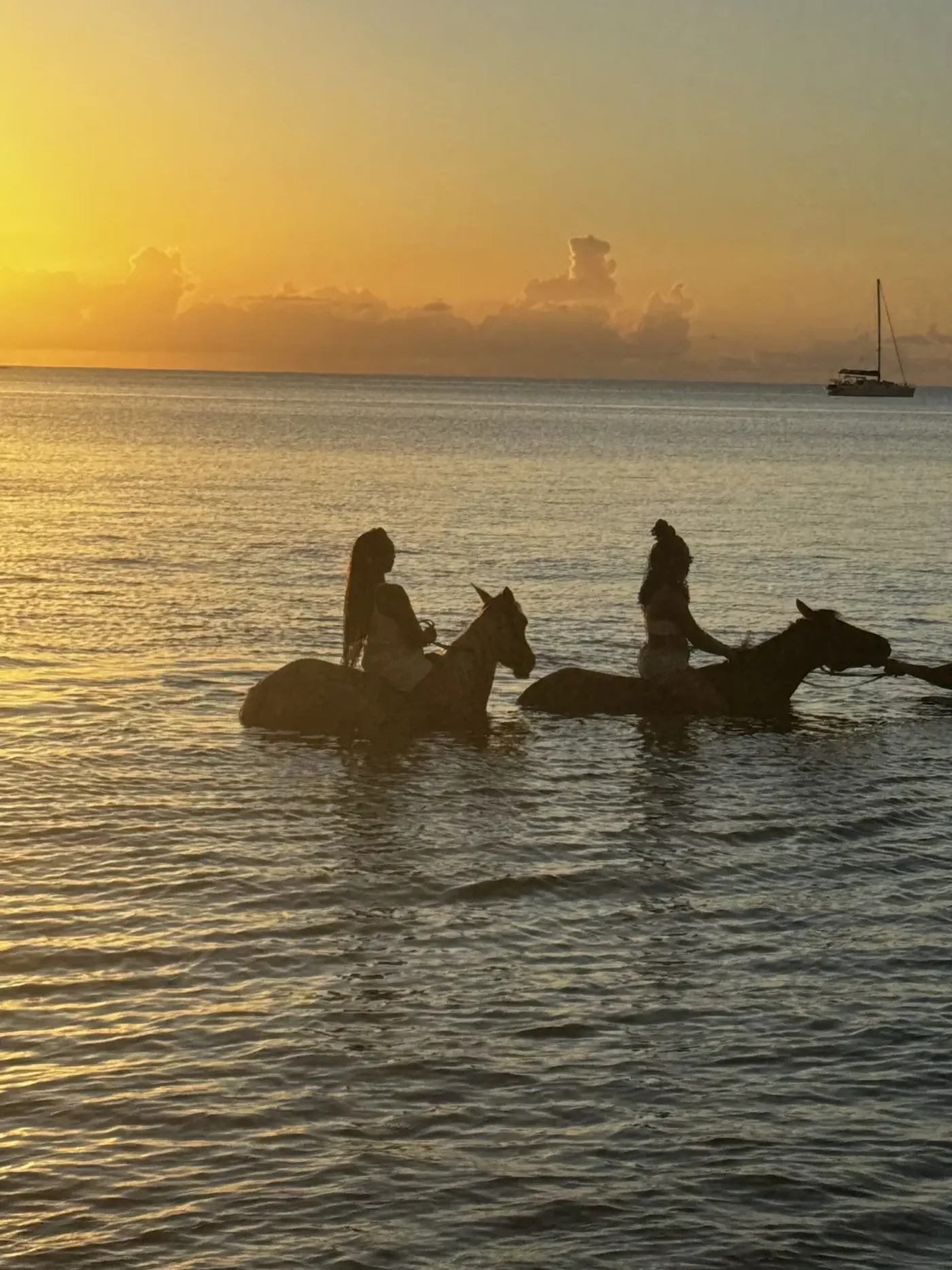 Two riders in the sea at first light
