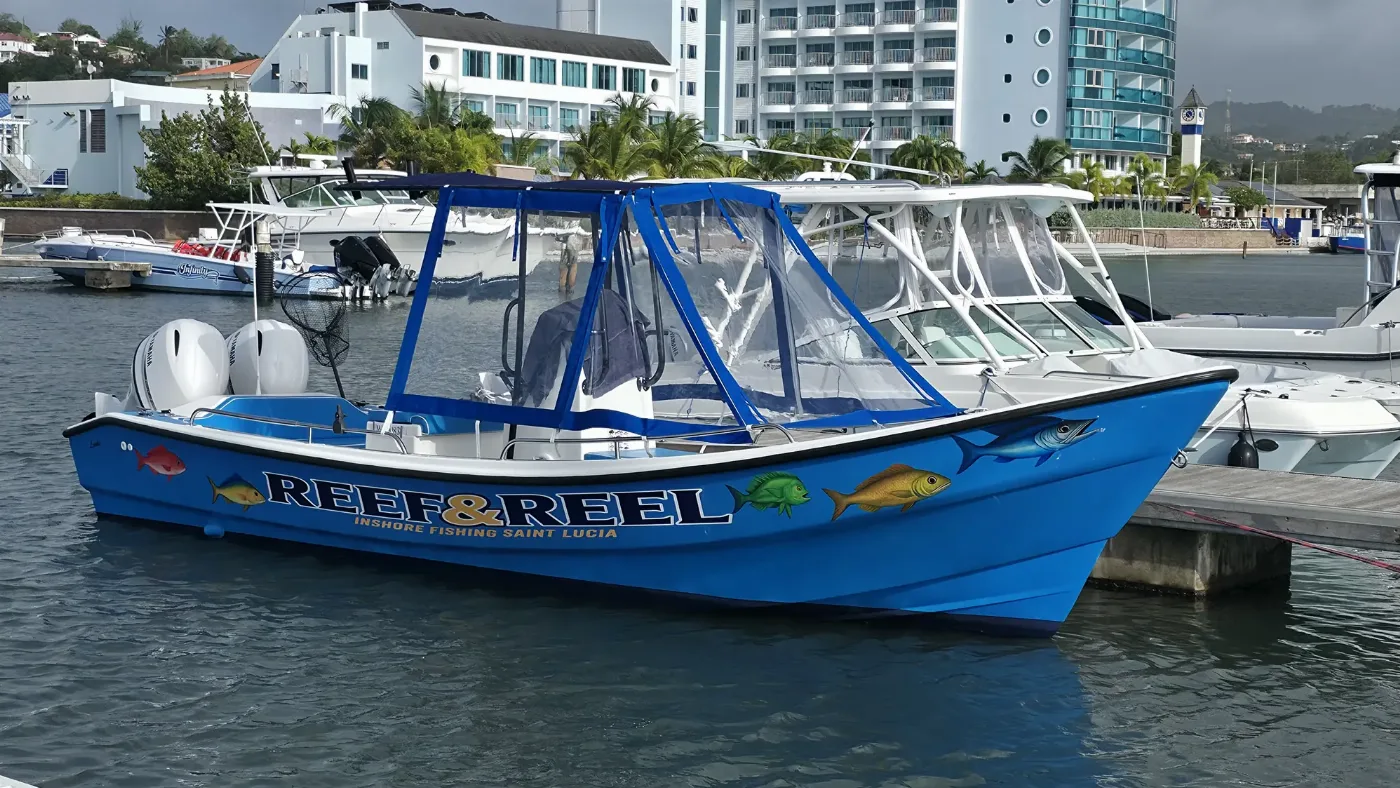 The bright blue Reef & Reel boat moored at Rodney Bay Marina